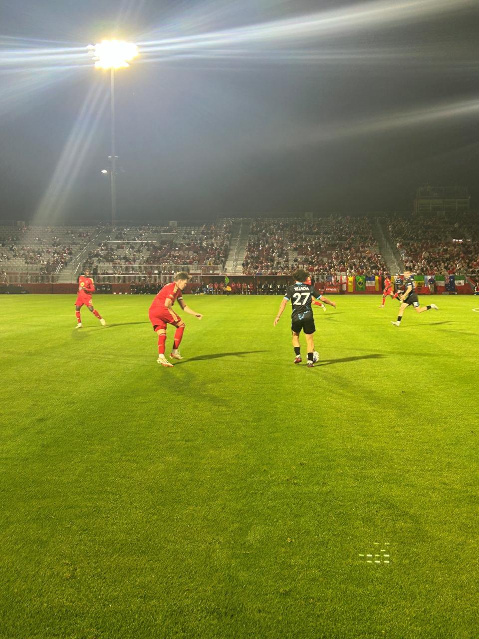 Phoenix Rising's John Stenberg (left) closes in on Colorado's Juan Tejada during Saturday's game at Phoenix Rising Stadium on April 13, 2024.