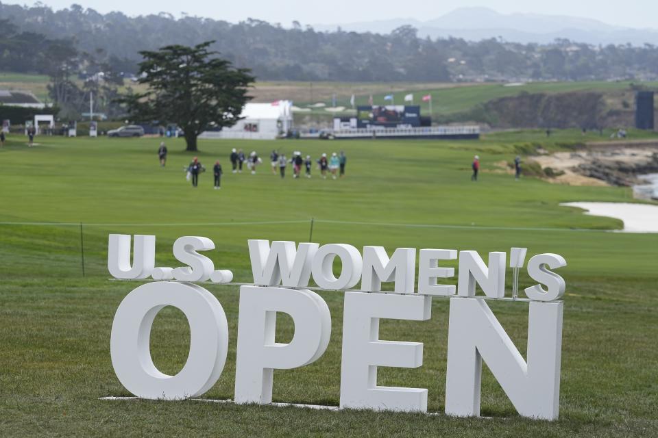 Golfers walks down the 18th fairway during a practice round for the U.S. Women's Open golf tournament at the Pebble Beach Golf Links, Tuesday, July 4, 2023, in Pebble Beach, Calif. (AP Photo/Darron Cummings)