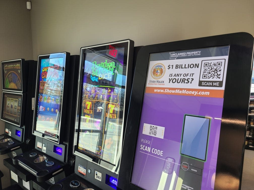 Torch Electronics games and a redemption kiosk displaying advertisements for the Unclaimed Property Program operated by State Treasurer Vivek Malek.