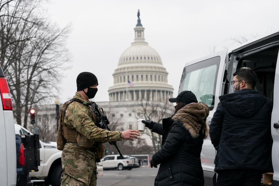 A U.S. Army National Guard soldier gets a cup of coffee as he guards the perimeter of the U.S. Capitol on Feb. 11 in Washington.