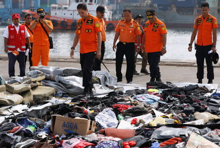 Chief of Indonesia's Lion Air flight JT610 search and rescue operations Muhammad Syaugi looks through recovered belongings believed to be from the crashed flight at Tanjung Priok port in Jakarta, Indonesia, October 30, 2018. REUTERS/Edgar Su