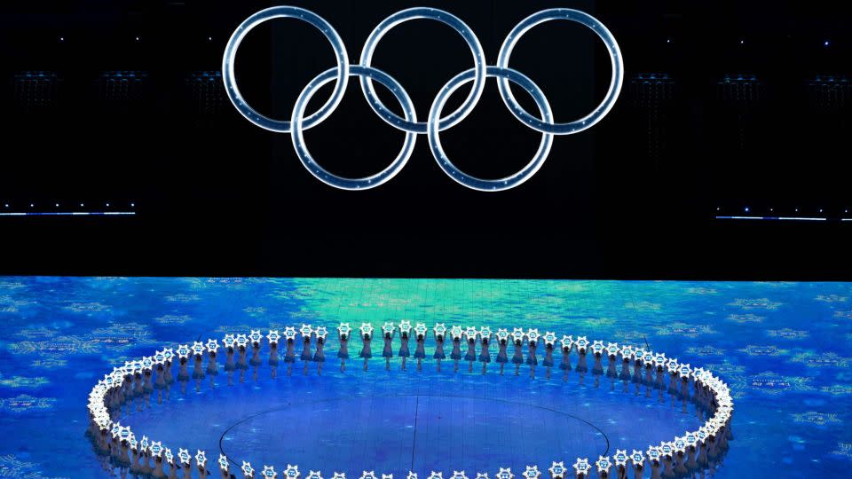 A general view shows performers hold signs with the name of participating countries under the Olympic rings during the opening ceremony of the Beijing 2022 Winter Olympic Games, at the National Stadium, known as the Bird's Nest, in Beijing, on February 4, 2022. - Jewel Samad/AFP/Getty Images