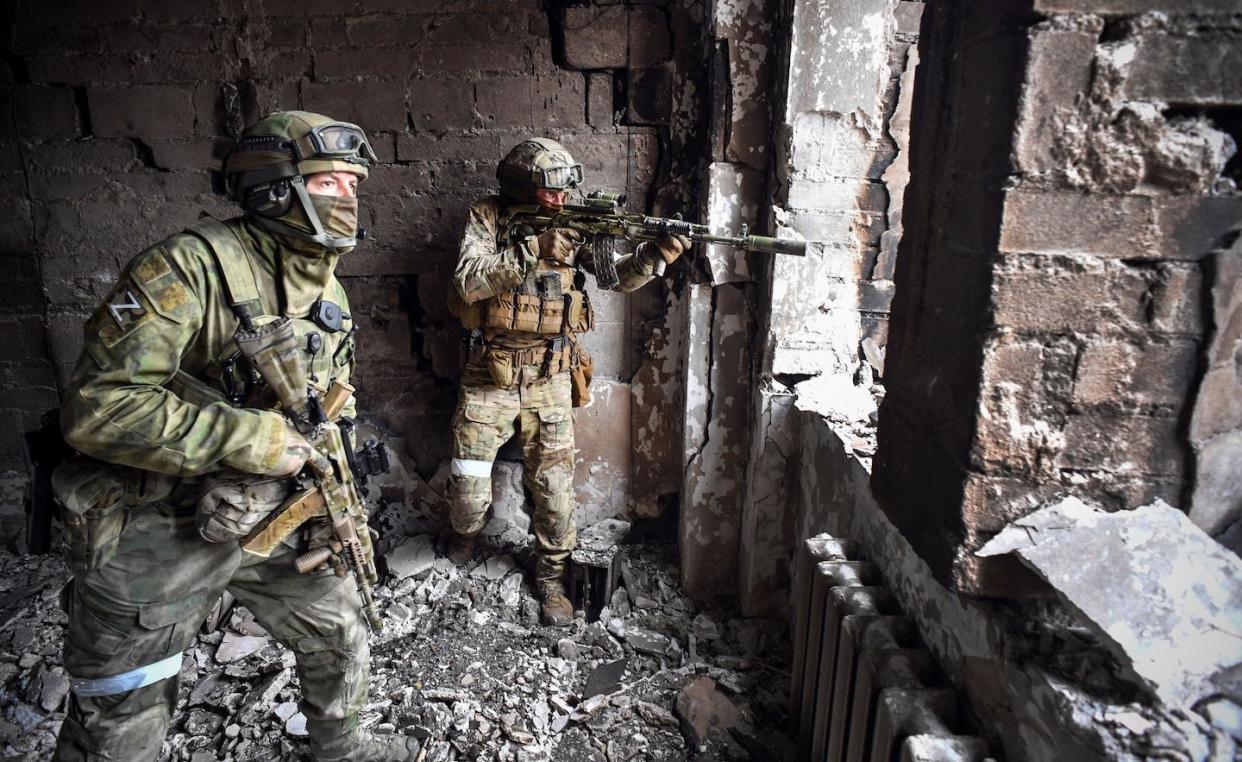 Russian soldiers patrol a theater in Mariupol, Ukraine, on April 12, 2022. <a href="https://media.gettyimages.com/photos/russian-soldiers-patrol-at-the-mariupol-drama-theatre-bombed-last-16-picture-id1239934899" rel="nofollow noopener" target="_blank" data-ylk="slk:Alexander Nemenov/AFP via Getty Images;elm:context_link;itc:0;sec:content-canvas" class="link ">Alexander Nemenov/AFP via Getty Images </a>