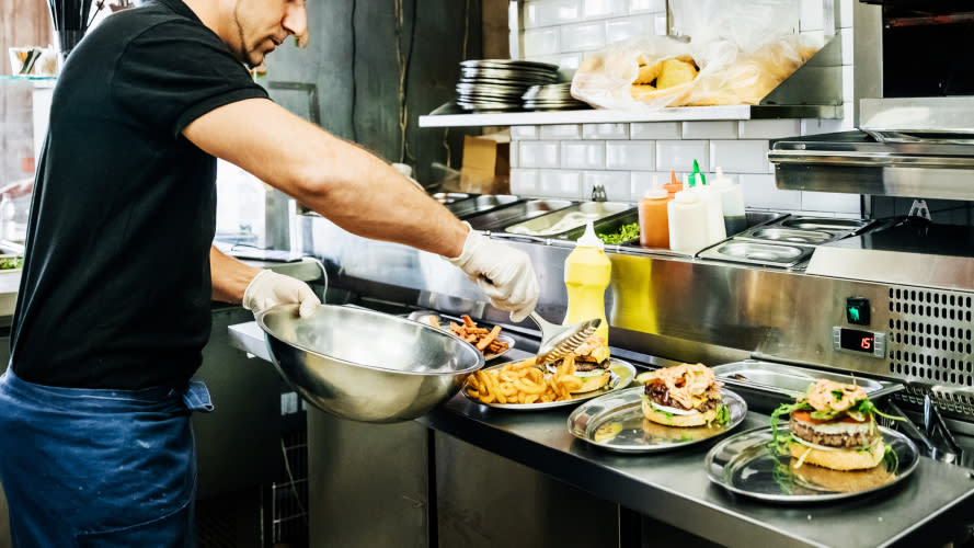 A chef working in the kitchen of a cafe.