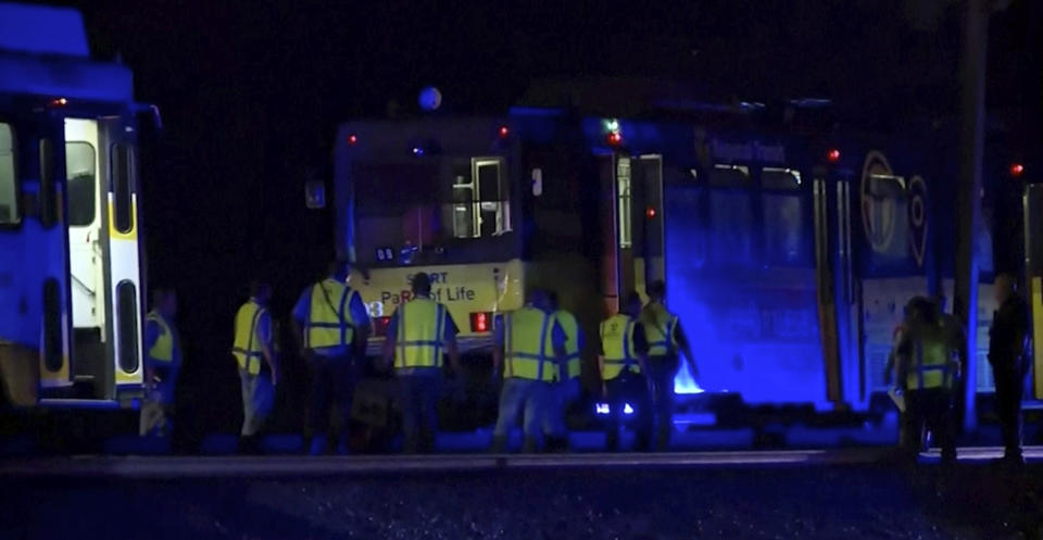 In this image from video, emergency works gather around a light rail train after derailment in Sacramento, Calif., Thursday night, Aug. 22, 2019. Authorities say more than two dozen people have been injured in the light rail train derailment in Northern California. (KOVR via AP)