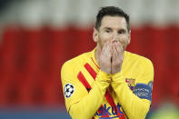 FILE - In this Wednesday, March 10, 2021 file photo Barcelona's Lionel Messi reacts after a missed a penalty shot during the Champions League, round of 16, second leg soccer match between Paris Saint-Germain and FC Barcelona at the Parc des Princes stadium in Paris. Neither Lionel Messi nor Cristiano Ronaldo will be in the Champions League quarterfinals for the first time since 2005. The two greatest players of the current generation were both eliminated from the competition this week. Messi scored a goal but missed a penalty as Barcelona was eliminated by Paris Saint-Germain. Ronaldo and his Juventus teammates were ousted by Porto the night before. Ronaldo has won five Champions League titles in his career. Messi has won four. (AP Photo/Christophe Ena, File)