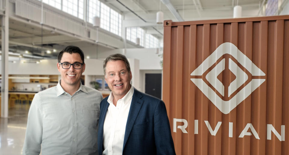 Rivian CEO RJ Scaringe and Ford Executive Chairman Bill Ford are shown together at a Rivian facility