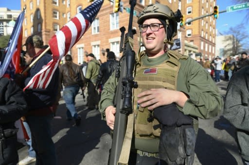 A pro-gun supporter from Buffalo, New York, carries a high-caliber sniper rifle during a gun rights rally by thousands of people outside the Virginia State Capitol grounds in Richmond, Virginia