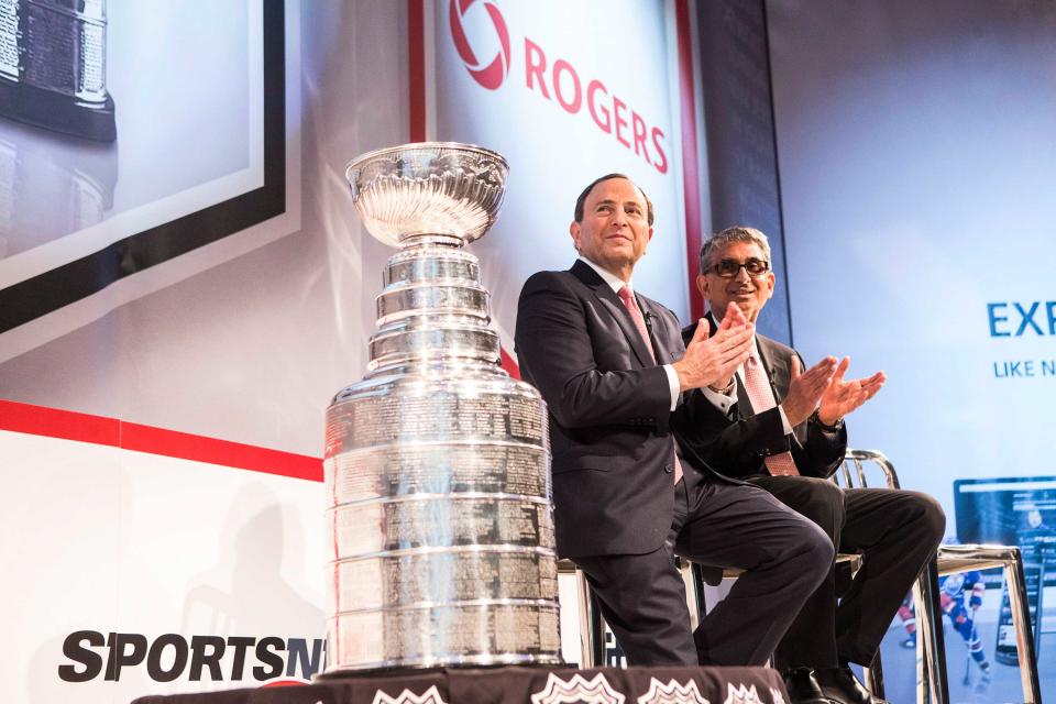 Rogers CEO Nadir Mohamed (right) sits with NHL Commissioner Gary Bettman at a news conference in Toronto on Tuesday 26, 2013