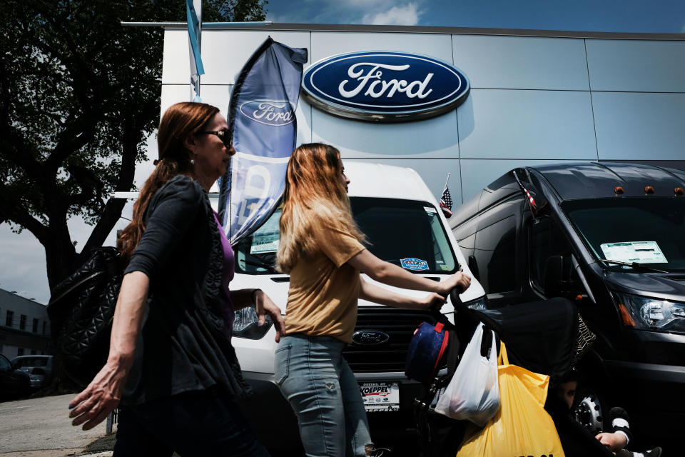 Women walks past cars for sale at a Ford dealership on May 20, 2019 in the Queens borough of New York City. (Photo: Spencer Platt/Getty Images)