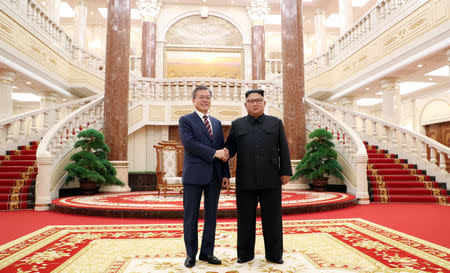 South Korean President Moon Jae-in shakes hands with North Korean leader Kim Jong Un as they arrive for their meeting at the headquarters of the Central Committee of the Workers' Party of Korea in Pyongyang. Pyeongyang Press Corps/Pool via REUTERS