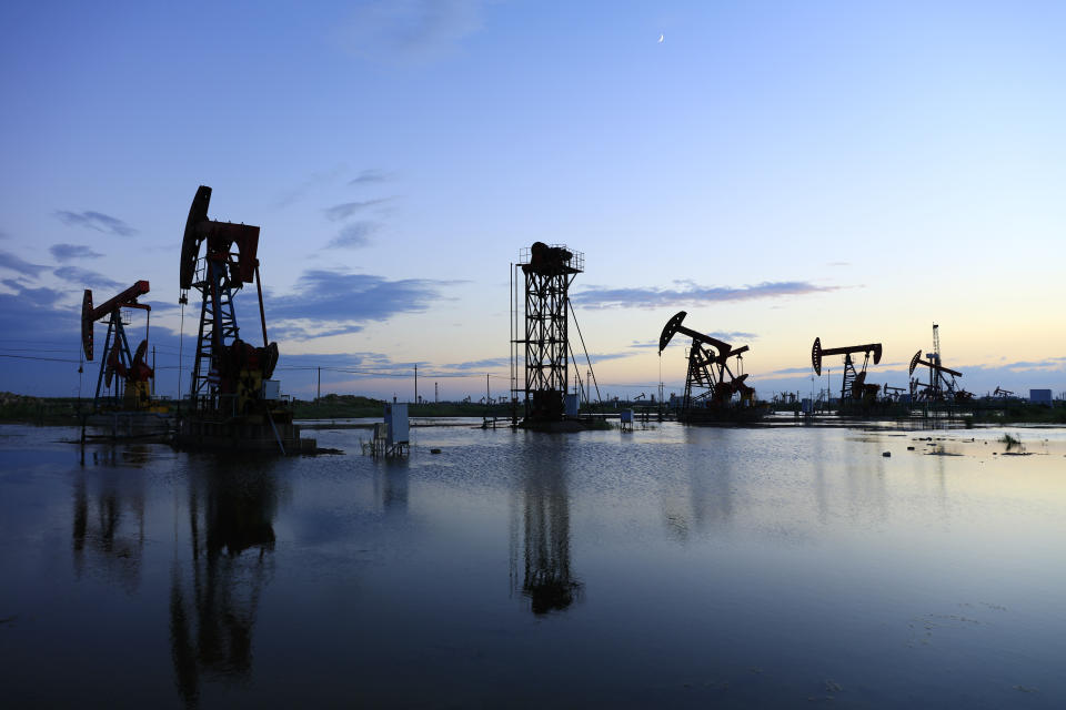 Oil fields in the evening, oil field derrick in the evening,  sunset and sunset