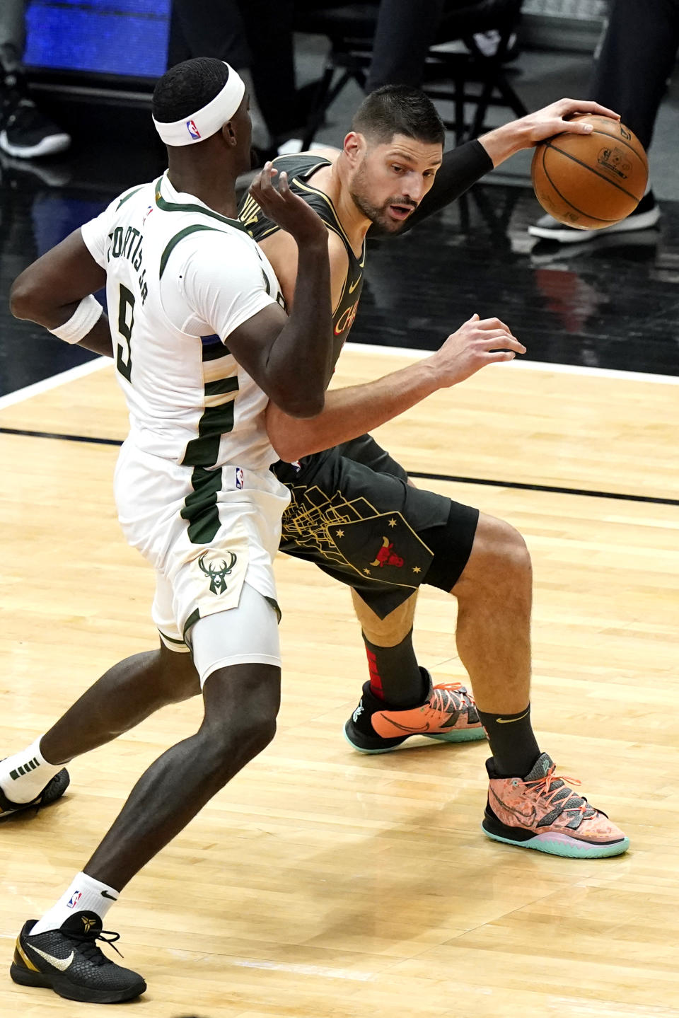 Chicago Bulls center Nikola Vucevic, right, drives against Milwaukee Bucks center Bobby Portis during the first half of an NBA basketball game in Chicago, Friday, April 30, 2021. (AP Photo/Nam Y. Huh)