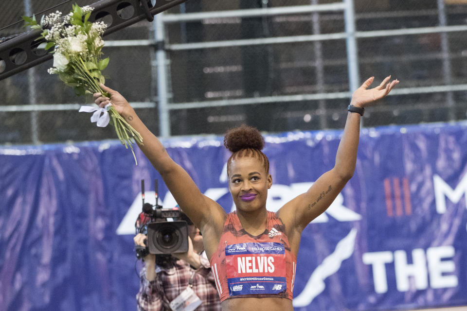 Sharika Nelvis, left, waves at the crowd after winning the women's 60-meter hurdles event at the Millrose Games track and field meet, Saturday, Feb. 9, 2019, in New York. (AP Photo/Mary Altaffer)