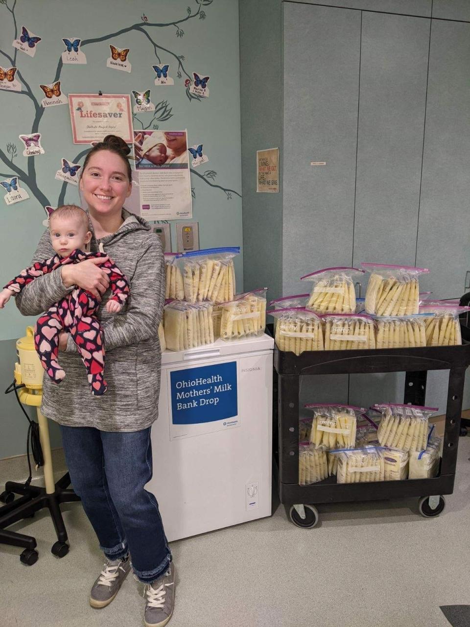 Alia Ross and her baby stand next to a few of the more than 55 gallons of breast milk they've donated to children in need at OhioHealth Mansfield Hospital.