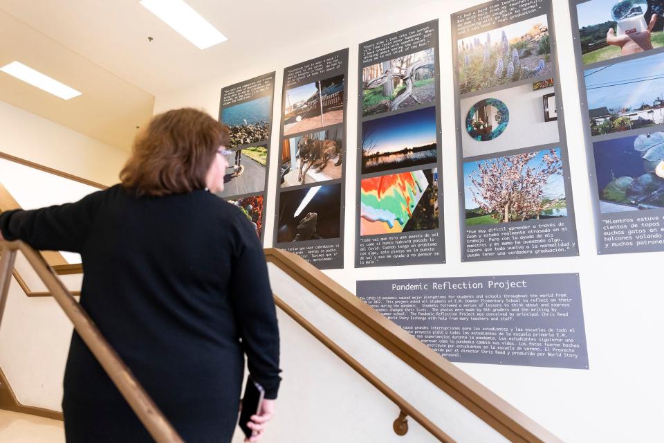 Vice Principal Ruby Gonzalez looks at the student Pandemic Reflection Project that is displayed at Downer.