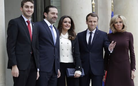 French President Emmanuel Macron (4R) and his wife Brigitte Macron (R) welcome Lebanese Prime Minister Saad Hariri (2R), his wife Lara Bachir El-Alzm (3R) and their son Houssam (L) - Credit: AFP