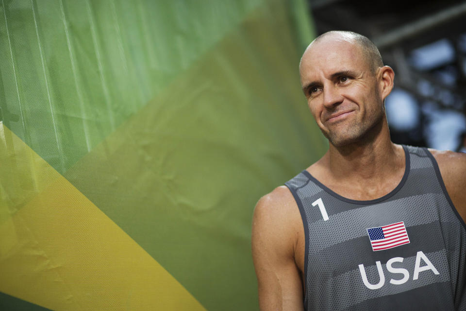 FILE - In this Aug. 8, 2016, file photo, Jake Gibb, of the United States, waits to be introduced to the crowd for a men's beach volleyball match against Austria at the Summer Olympics in Rio de Janeiro, Brazil. American beach volleyball player Taylor Crabb is out of the Olympics after several positive COVID-19 tests, and Tri Bourne will take his place as the partner of four-time Olympian Gibb when the competition begins at Tokyo’s Shiokaze Park this weekend. (AP Photo/David Goldman, File)