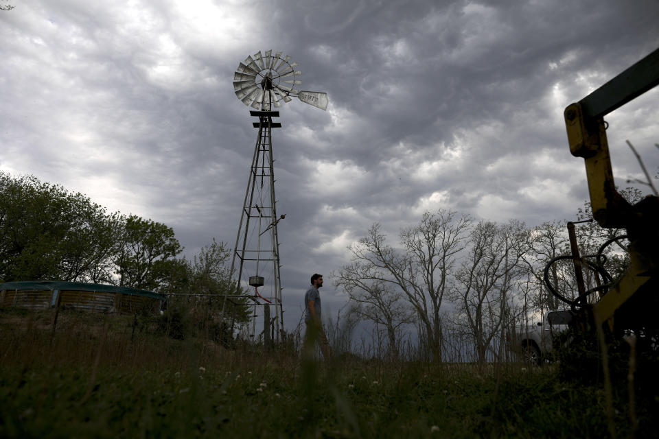 In this Oct. 9, 2019 photo, farmer Sebastian Campo walks on his farm on the outskirts of Pergamino, Argentina. Campo said that he's among a small minority of farmers who doesn't back Argentina's President Mauricio Macri in the upcoming Oct. 27 election, but will decide his vote at the booth. (AP Photo/Natacha Pisarenko)