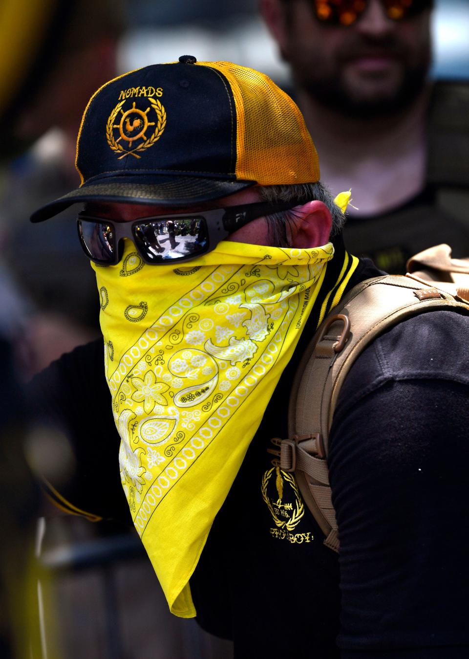 May 28, 2022; Houston, TX, USA; A member of the South Texas Proud Boys watches as police keep separate his group from the anti-gun demonstrators outside the George R. Brown Convention Center where the NRA was holding the second day of its national convention in Houston, Texas on Saturday May 28, 2022.