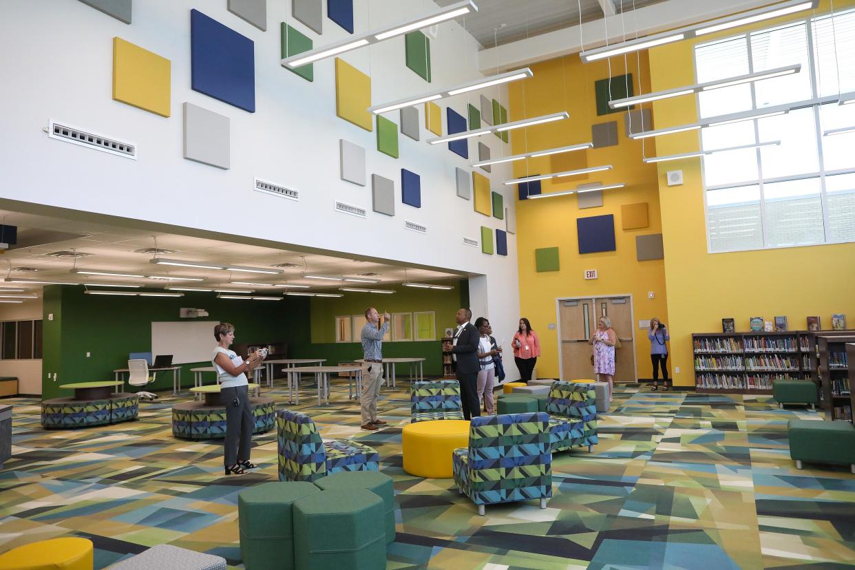 People walk thorough the media center during a tour after the ribbon-cutting ceremony at the new Terwilliger Elementary School in 2021.