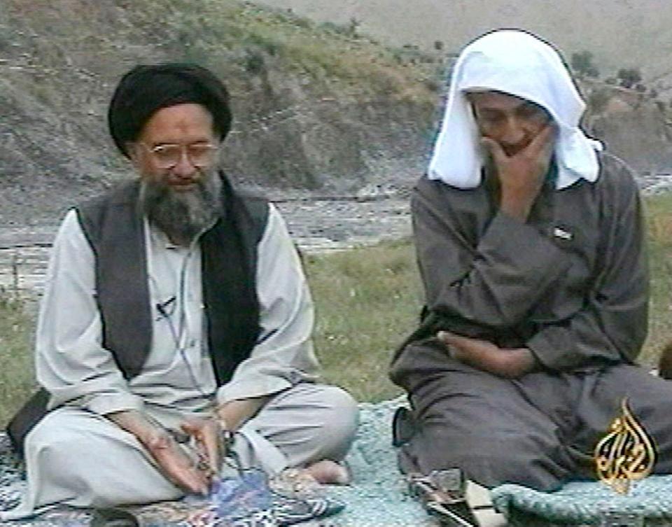 In this television image from Arab satellite station Al-Jazeera, Osama bin Laden, right, listens as his top deputy Ayman al-Zawahri speaks at an undisclosed location, in this image made from undated video tape broadcast by the station April 15, 2002.