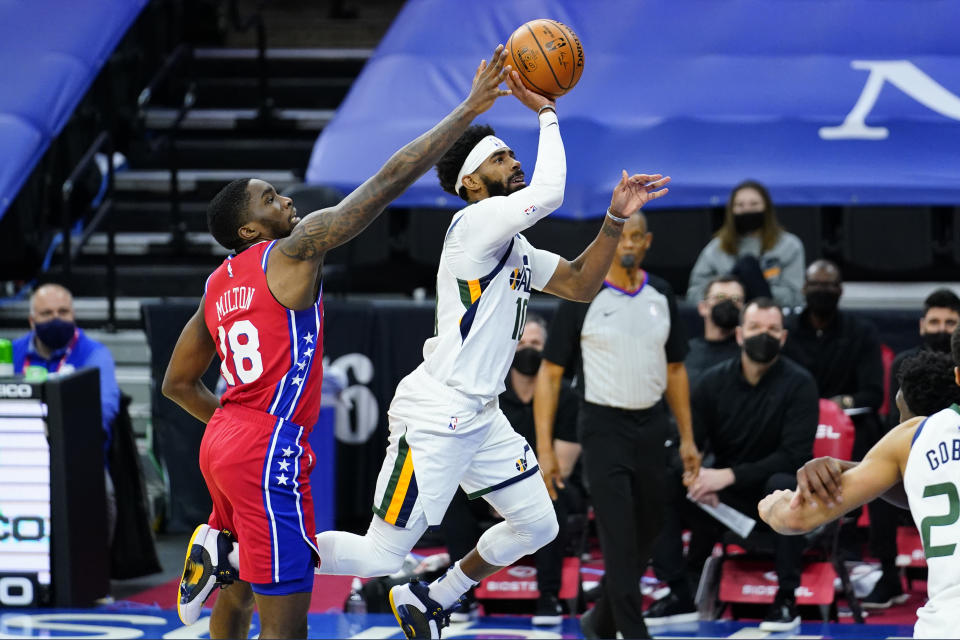 Utah Jazz's Mike Conley, right, tries to get a shot past Philadelphia 76ers' Shake Milton during overtime in an NBA basketball game, Wednesday, March 3, 2021, in Philadelphia. (AP Photo/Matt Slocum)