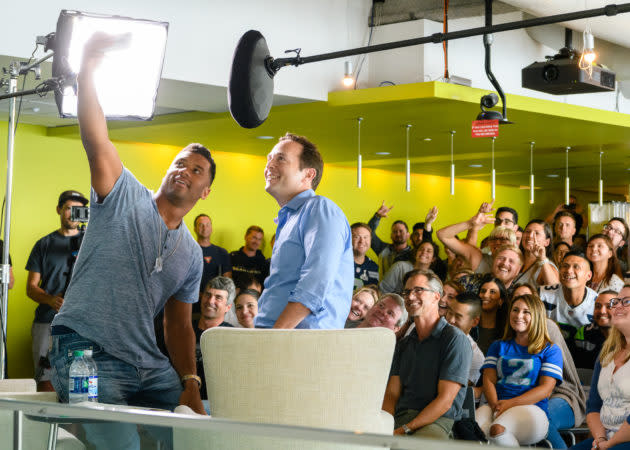 Russell Wilson records a video with Zillow Group employees and CEO Spencer Rascoff, with co-founder Rich Barton and Lloyd Frink in the front row in August. (GeekWire Photo / Kevin Lisota) <a href="https://www.geekwire.com/2018/seahawks-qb-russell-wilson-reveals-roots-real-estate-nerd-zillow-appearance/" rel="nofollow noopener" target="_blank" data-ylk="slk:Read the story.;elm:context_link;itc:0;sec:content-canvas" class="link "><strong>Read the story.</strong></a>