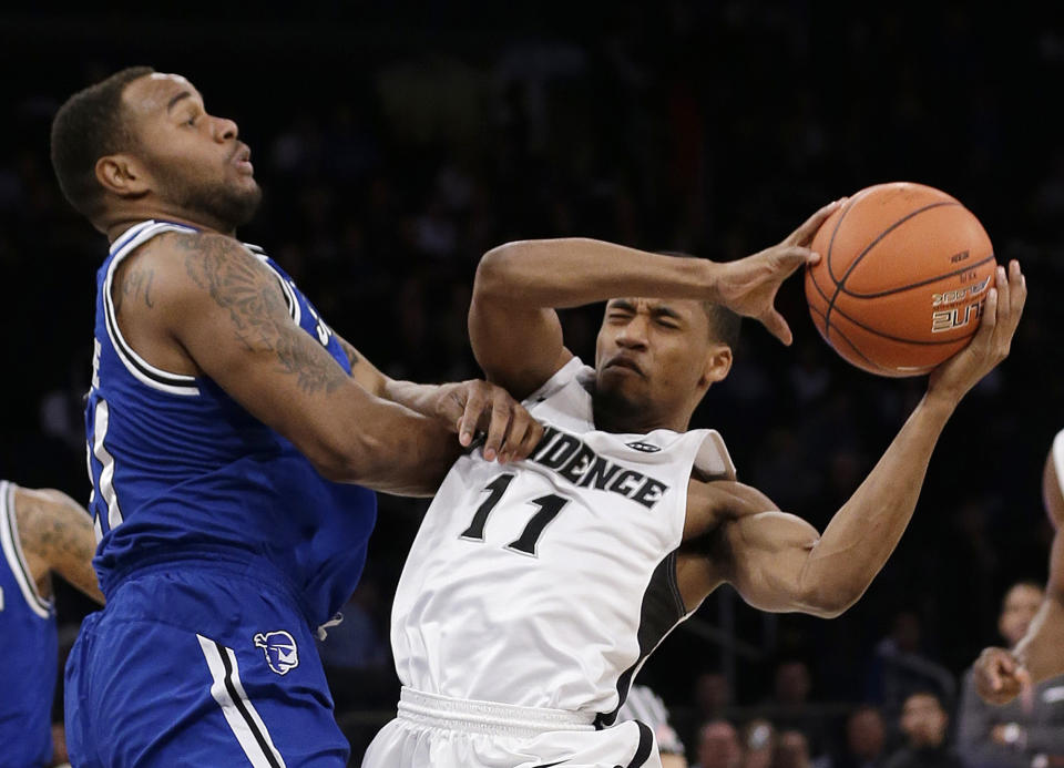 Seton Hall's Eugene Teague. left, fouls Providence's Bryce Cotton (11) during the first half of an NCAA college basketball game in the semifinals of the Big East Conference men's tournament Friday, March 14, 2014, at Madison Square Garden in New York. (AP Photo/Frank Franklin II)