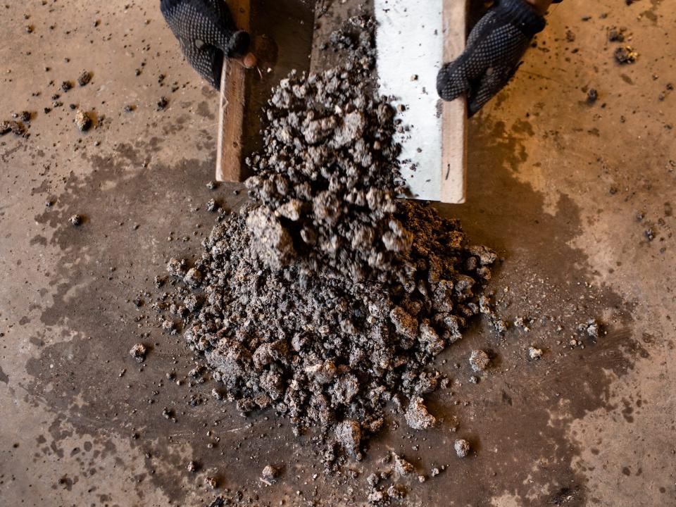 A miner crushes cobalt that will be tested for purity