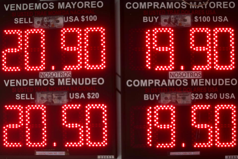 A board displaying exchange rates for Mexican peso and U.S. dollar is pictured at a currency exchange shop in downtown Mexico City, Mexico November 26, 2021. REUTERS/Edgard Garrido