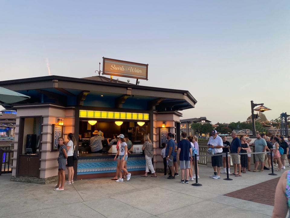 A line waits for Dole Whip at Disney Springs' Swirls on the Water booth.