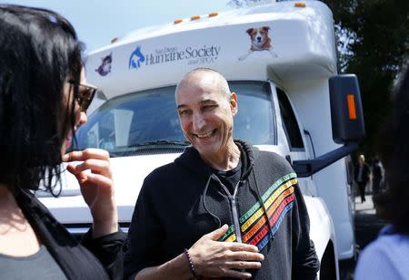 Hollywood mogul and co-creator of The Simpsons, Sam Simon, smiles while visiting a chinchilla farm after he financed the purchase of the facility by PETA (People for the Ethical Treatment of Animals) in order to rescue over 400 chinchillas and shutter the business in Vista, California August 19, 2014. REUTERS/Mike Blake