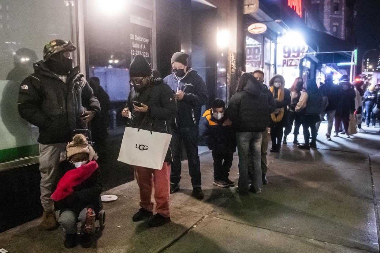 People wait on line to get tested for COVID-19 on the Lower East Side of Manhattan, Tuesday, Dec. 21, in New York. 