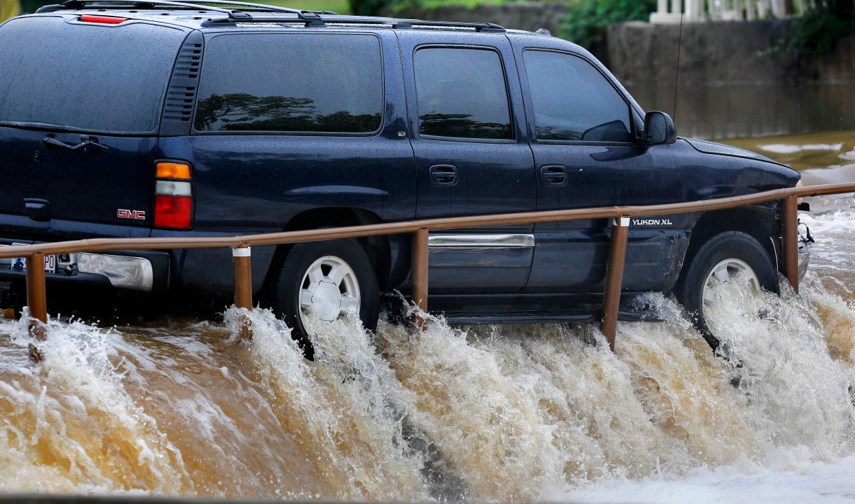Oklahoma City firefighters rescued a 58-year-old woman from her SUV on Sept. 27, 2017, after fast-moving water pinned the vehicle against guard rails on a spillway on Silver Lake Lane in the Ski Island neighborhood. The woman was not injured.