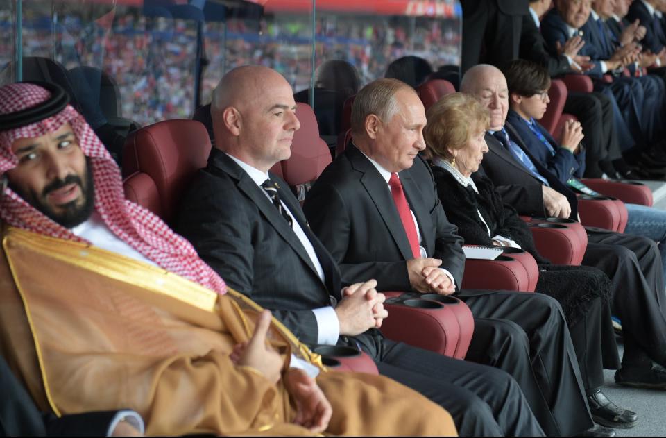 FILE - From left, Saudi Arabia Crown Prince Mohammed bin Salman, FIFA President Gianni Infantino, and Russian President Vladimir Putin watch the match between Russia and Saudi Arabia which opens the 2018 soccer World Cup at the Luzhniki stadium in Moscow, Russia, Thursday, June 14, 2018. The near certainty that Saudi Arabia will host the 2024 men's World Cup unites two of the most influential men in world sports: the leader of soccer's governing body and the kingdom's crown prince. (Alexei Druzhinin, Sputnik, Kremlin Pool Photo via AP, File)