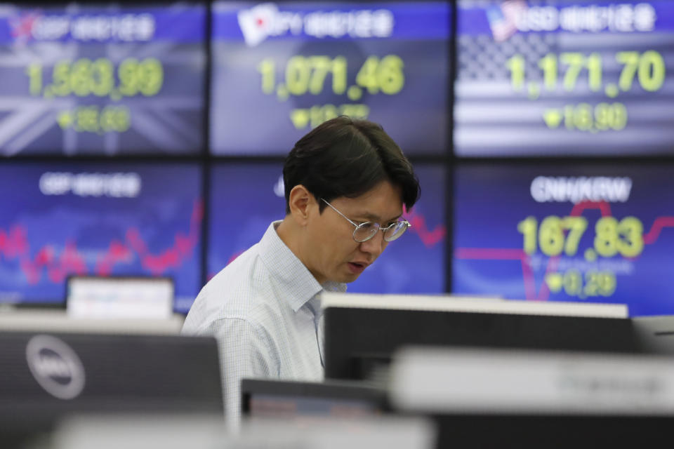 A currency traders watches monitors at the foreign exchange dealing room of the KEB Hana Bank headquarters in Seoul, South Korea, Monday, Dec. 16, 2019. Asian stock markets were mixed Monday following a U.S.-Chinese trade deal that disappointed some investors. (AP Photo/Ahn Young-joon)