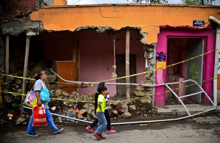 Batttered by earthquakes in September, Mexico's economy shrank in the third quarter for the first time in more than four years. This Mexico City home collapsed in the September 19 earthquake