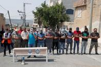 FILE PHOTO: Palestinians protest against normalizing ties with Israel in the occupied West Bank