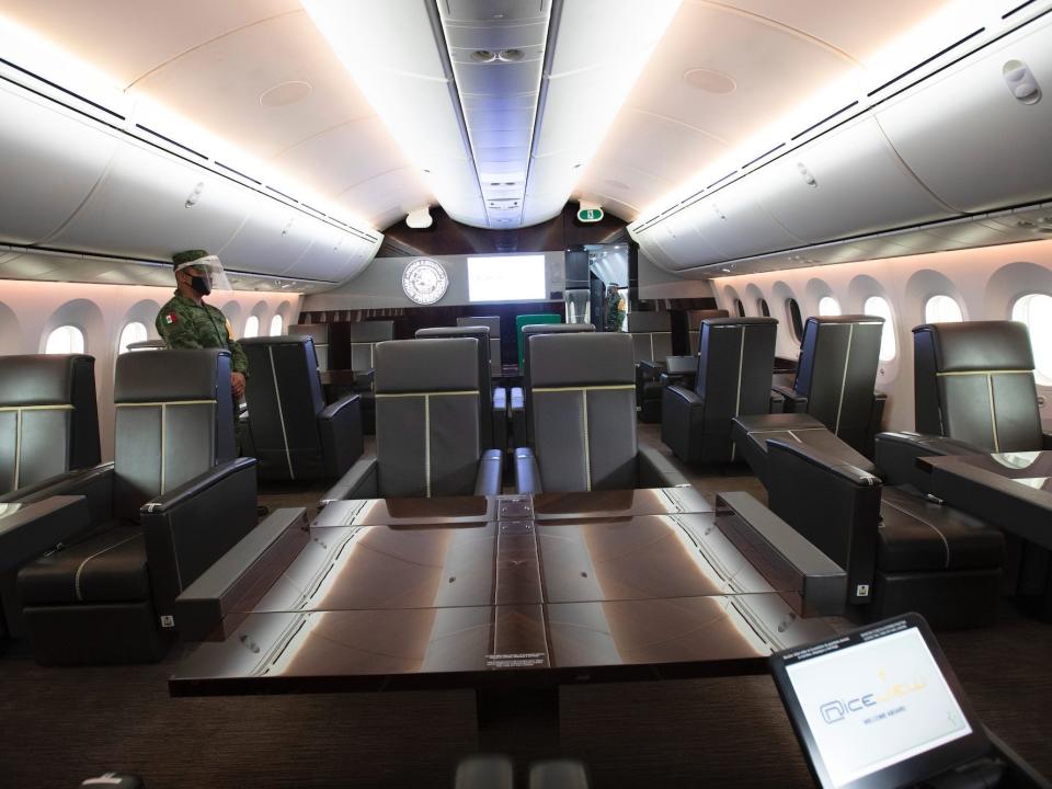 Brown tables and grey loungers inside Mexico's former VIP Boeing 787.
