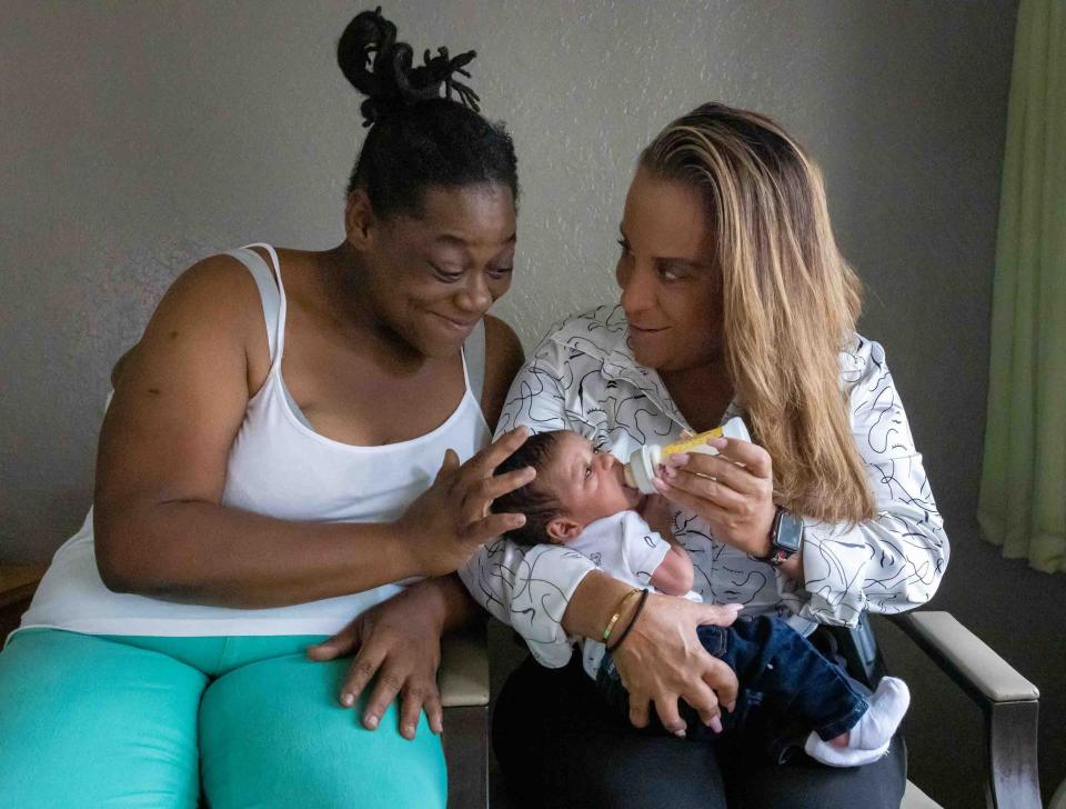 Riviera Beach Police Detective Jennifer Jones, right, holds 21/2-week-old I'keem Timmons inside a West Palm Beach Studio 6 motel as his mother, Tyshameka Griffin, watches. When I'keem and Griffin were discharged from St. Mary's Medical Center, they had no place to stay. Jones collaborated with local organizations and managed to secure temporary housing for the mother and baby.