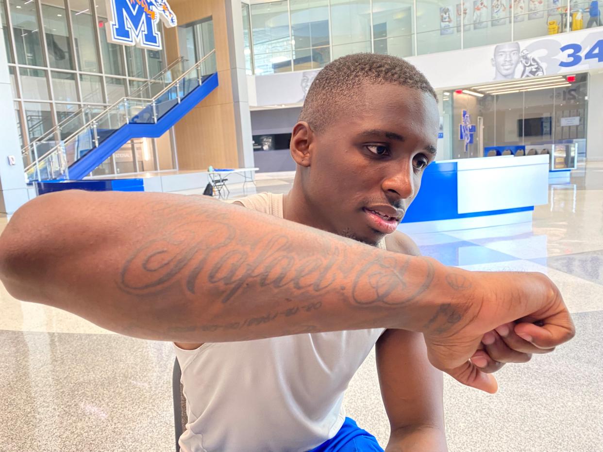 Memphis basketball wing David Jones shows off the tattoo of his mother's name on his right arm.