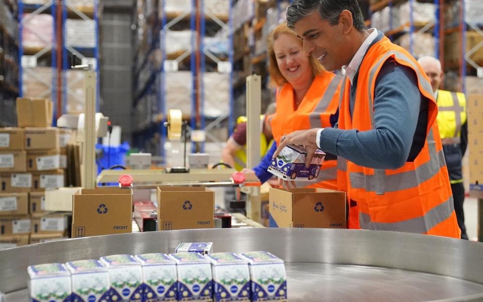 Rishi Sunak packs products with Attorney General and parliamentary candidate for Banbury, Victoria Prentis during a visit to DCS Group in Banbury, Oxfordshire