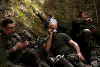 Territorial soldiers take a break during their training for Poland's Territorial Defence Forces near a shooting range near Siedlce, Poland, April 21, 2018. REUTERS/Kacper Pempel/Files