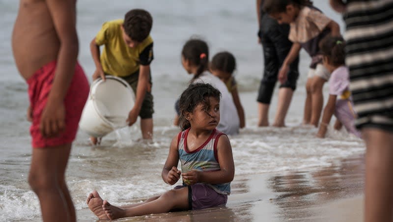 Palestinians spend the day on the beach along the Mediterranean Sea during a heatwave in Deir al Balah, Gaza Strip, Thursday, April 25, 2024. Over 80% of Gaza's population has been displaced by the ongoing war with Israel, and many have relocated to the area. Temperatures hovered near 37 degrees Celsius (100 degrees Fahrenheit). (AP Photo/Abdel Kareem Hana)