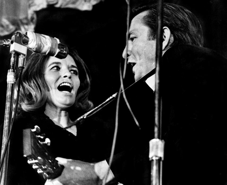 Johnny Cash, right, and his wife, June Carter Cash, team up in a rousing, close-harmony rendition of their hit "Jackson" for the delighted audience, the inmates at Tennessee State Prison in Nashville Dec. 14, 1968.