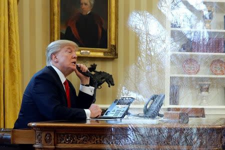 U.S. President Donald Trump waits to speak by phone with the Saudi Arabia's King Salman in the Oval Office at the White House in Washington, U.S. January 29, 2017. REUTERS/Jonathan Ernst