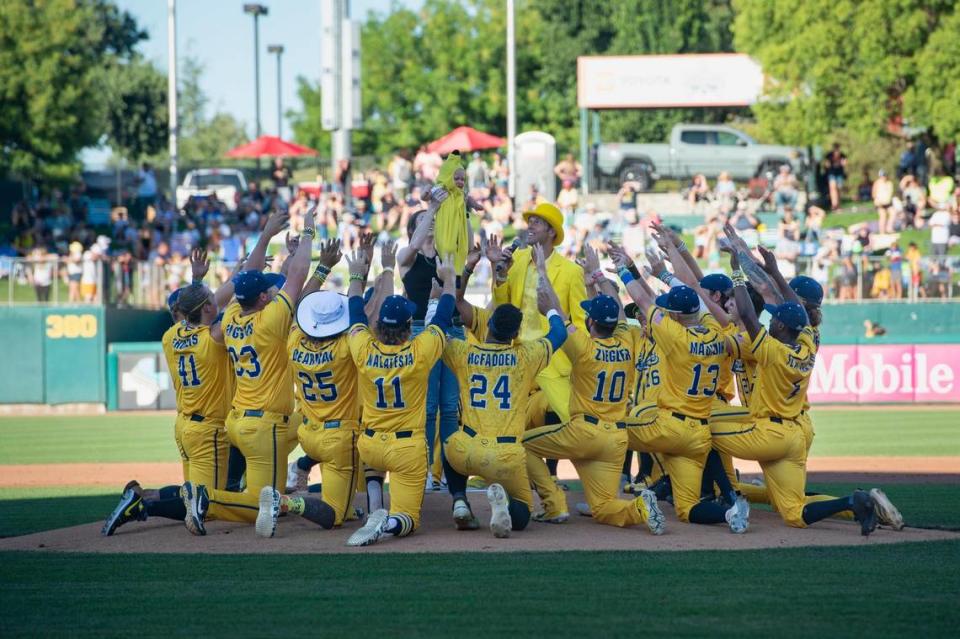 Nicole Helton-Glommen holds up her 11-month-old son Cooper as he is presented as the “Banana Baby” during the Savannah Bananas World Tour on Saturday, July 29, 2023, at Sutter Health Park in West Sacramento.