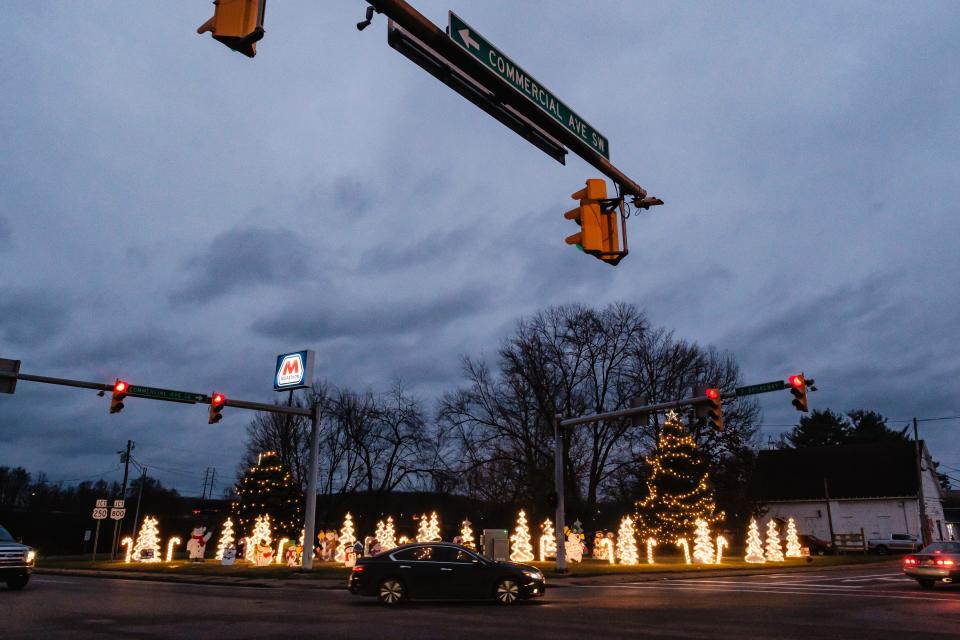 Motorists pass by the Christmas display at the corner of Commercial Avenue SE and South Broadway Street, Tuesday, Dec. 19 in New Philadelphia.