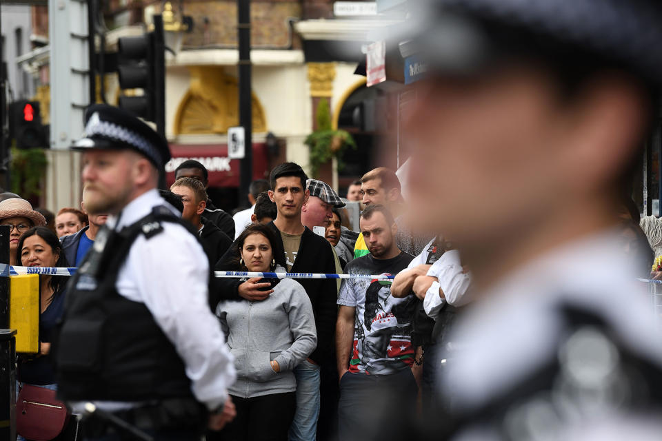 People standing behind police cordon